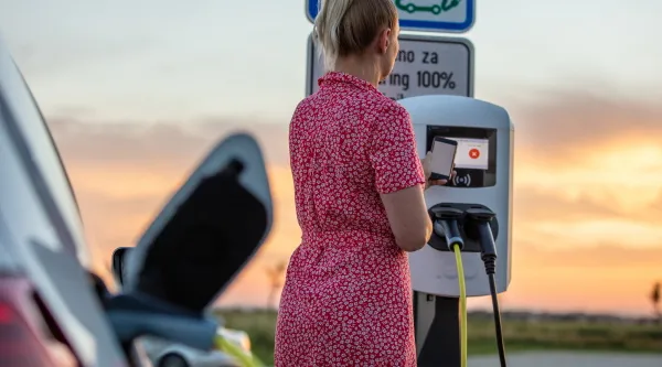 Woman paying for electric car charging
