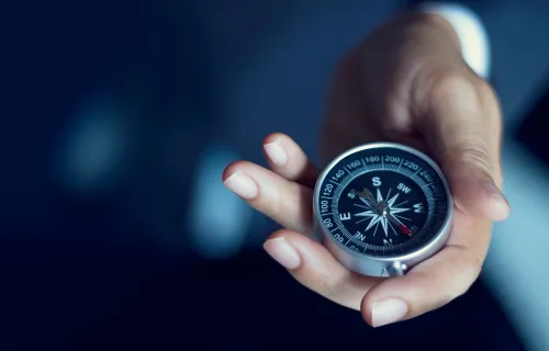 Compass being held in a hand