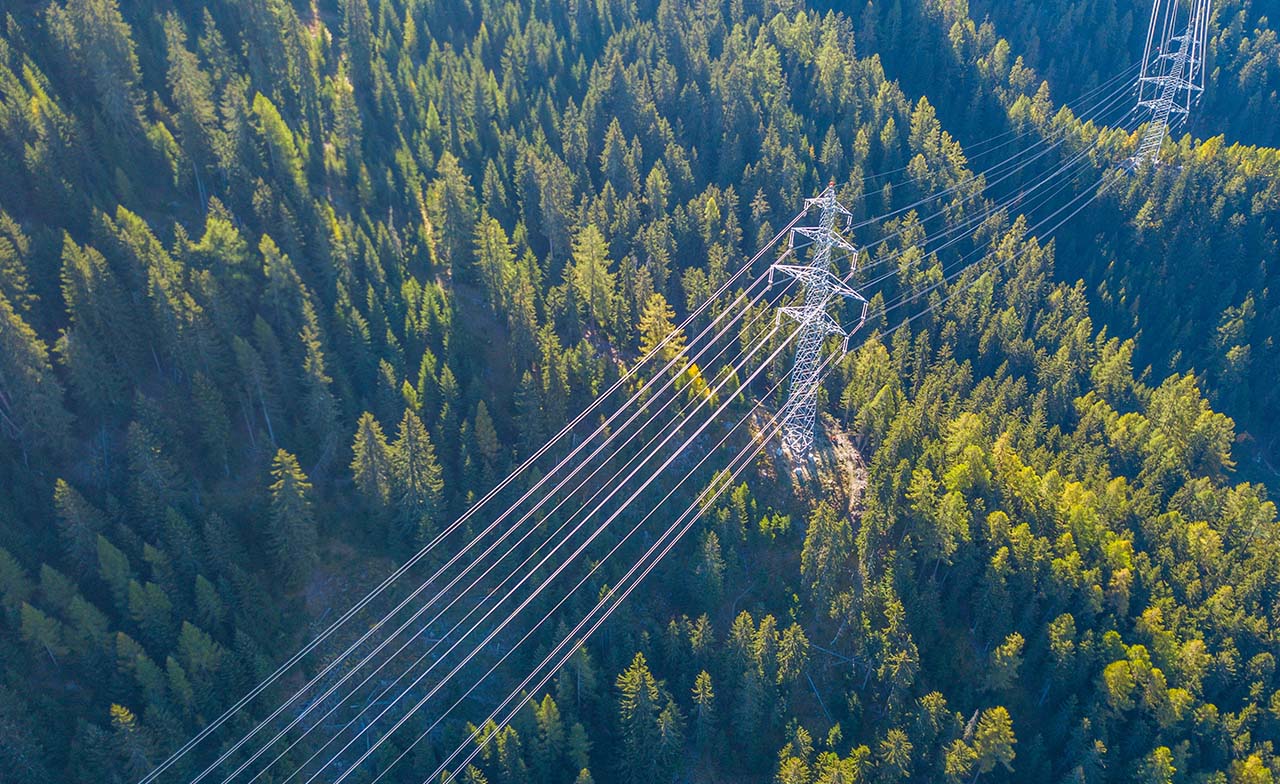 Aerial view of power line pylon in mountainous area