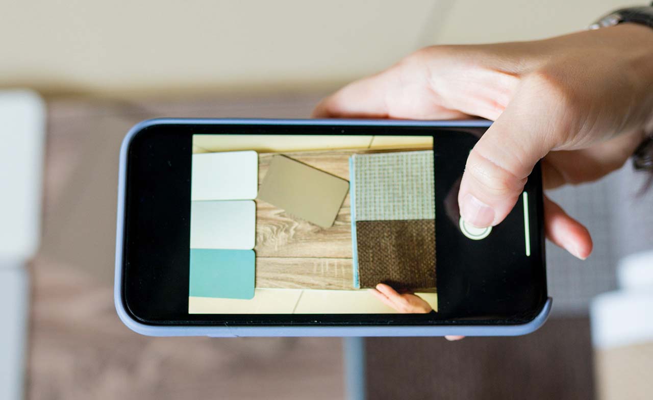 Top view of someone using a mobile device for home renovation