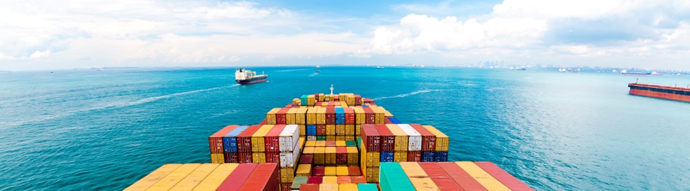 A container ship at sea viewed from the stern
