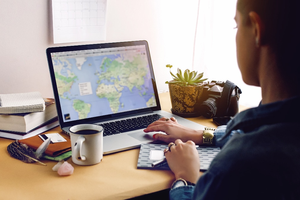man looking at a map on his laptop