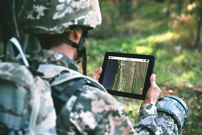 soldier looking a satellite data