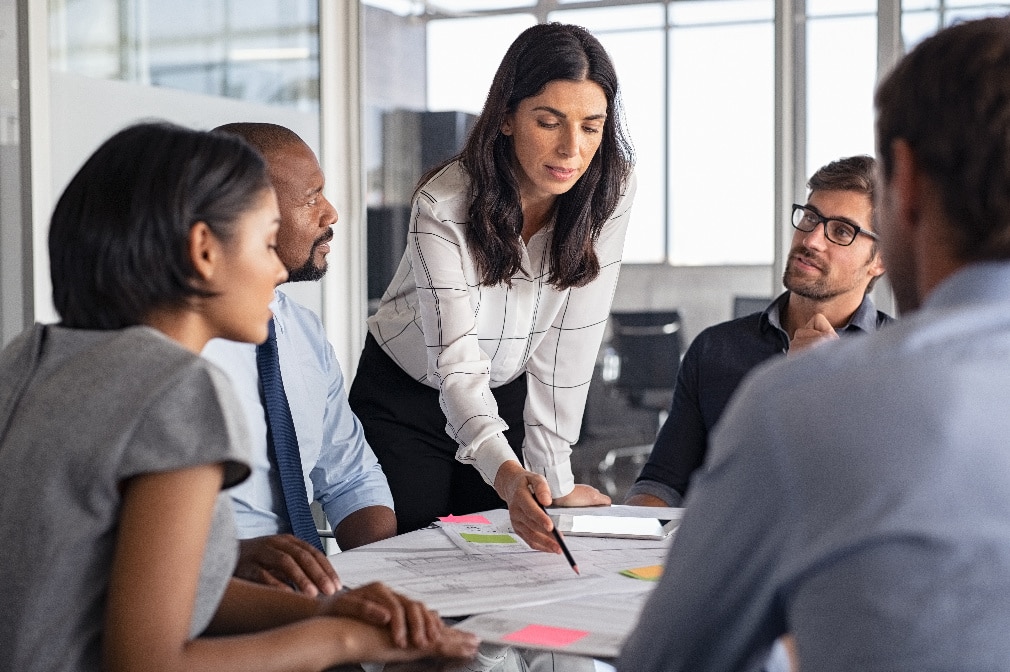 Équipe de professionnels réunie autour d’une table lors d’une séance de travail collaborative