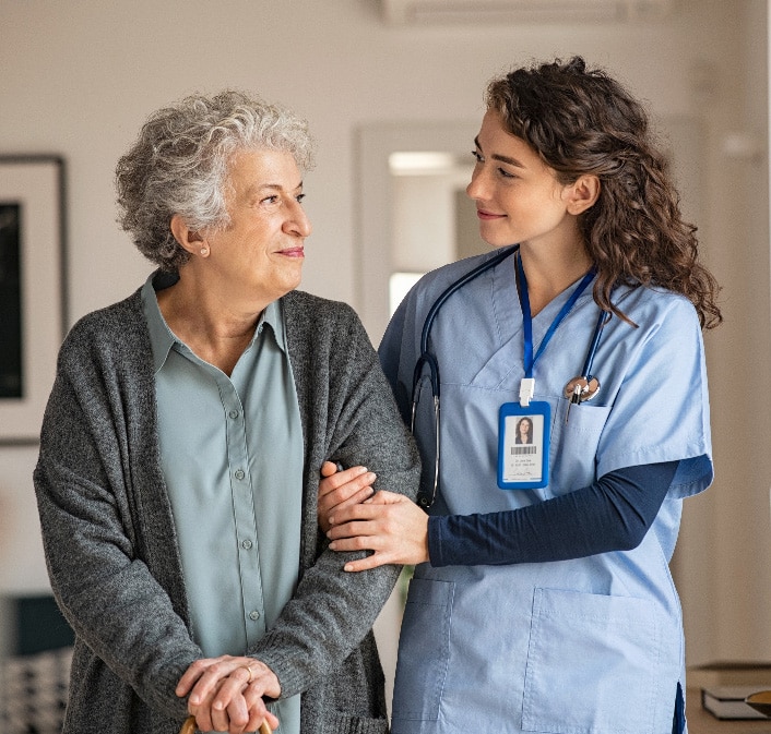 Caregiver assist senior woman at home