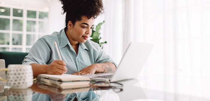 woman working on her computer at table