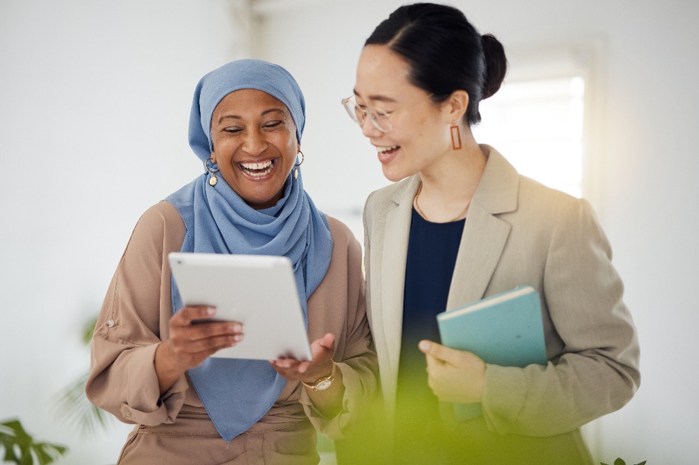 three women leaning against table