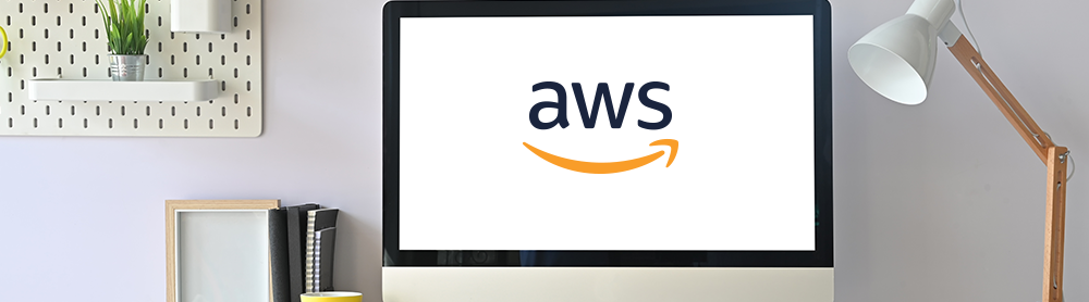 Minimalist and modern desk set up with computer monitor displaying AWS logo 