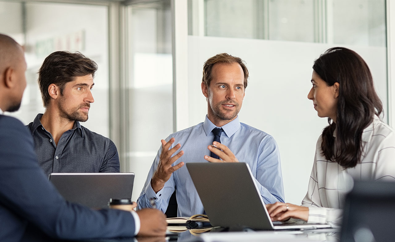 consultants and client talking at table