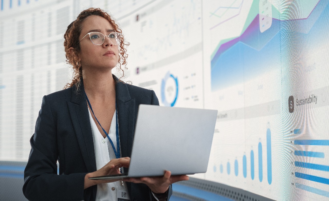 Business analyst reviewing hybrid cloud data