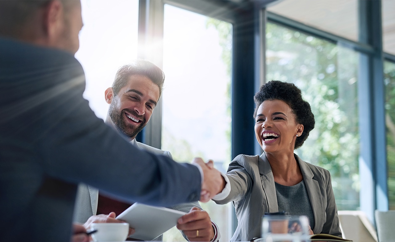 Business people shaking hands in the office for a deal. Business people shaking hands in the office for a deal.