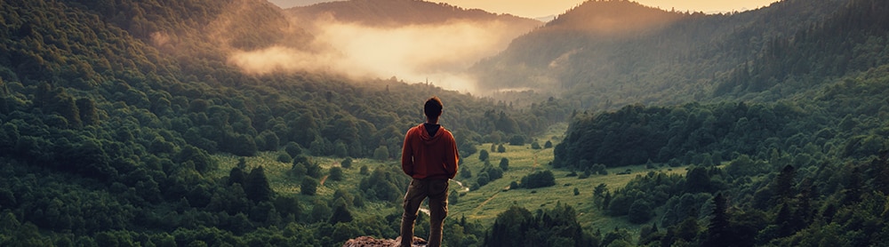 careers person on top of a mountain with a view and sunset