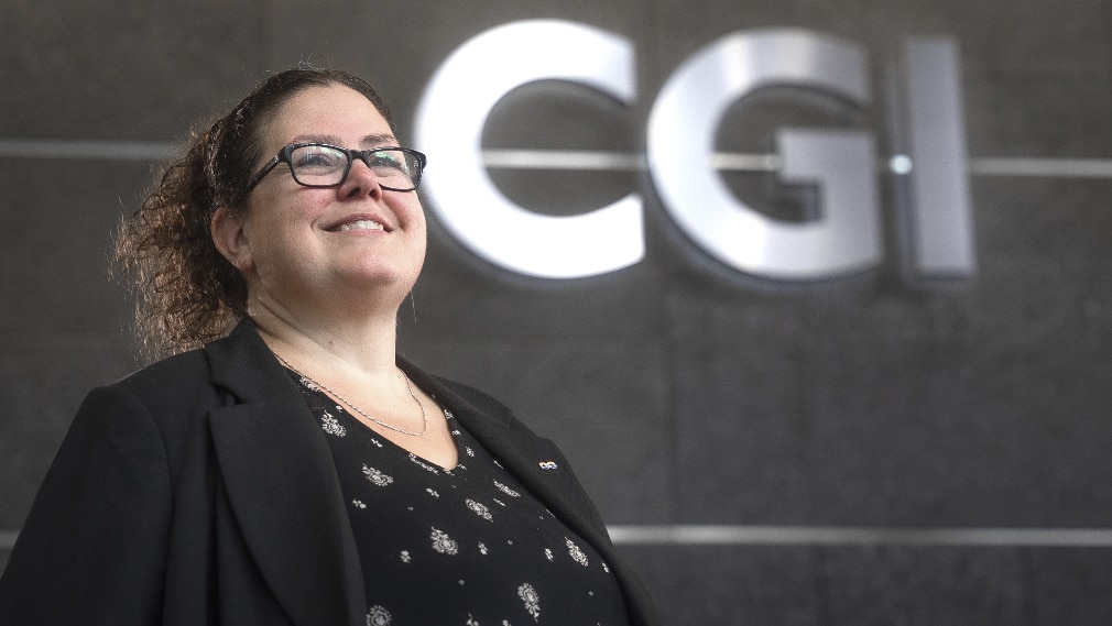 consultant in front of CGI logo consultant in front of CGI logo