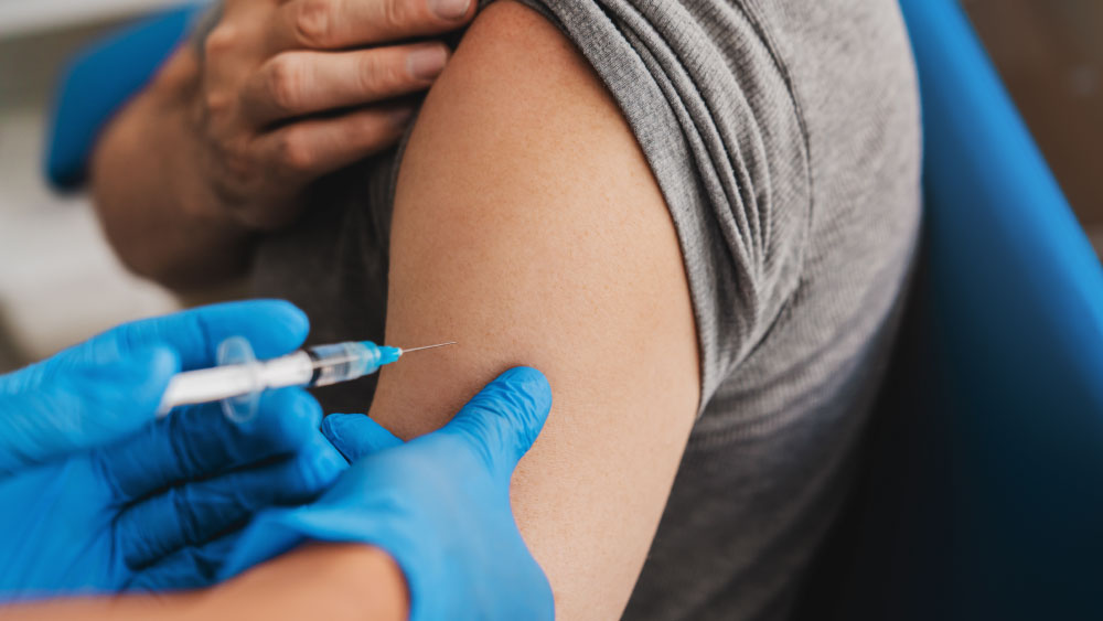 Patient receiving vaccination in shoulder