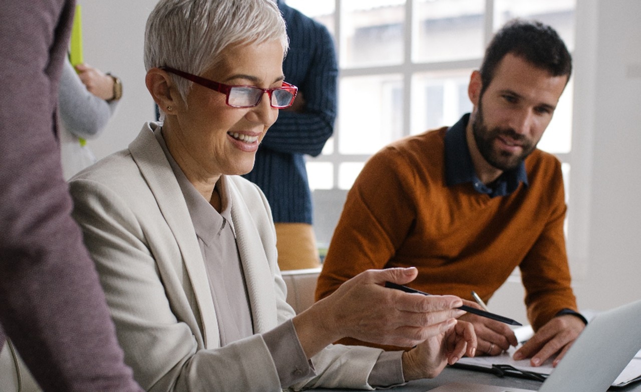 man and woman looking at laptop screen