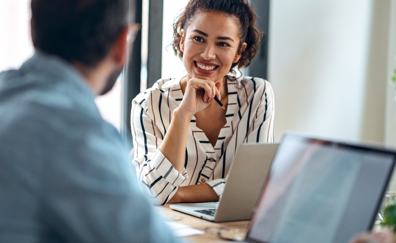 Cloud consultants look at laptop together
