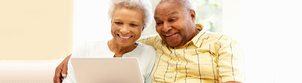 elderly couple using laptop