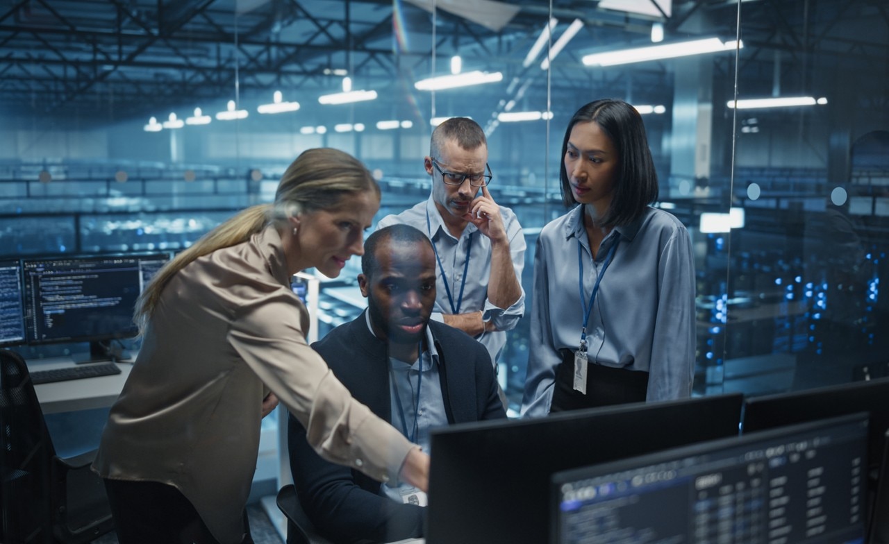 Consultants gather round computer