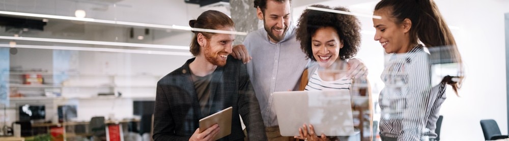 Consultants smiling looking at tablet together
