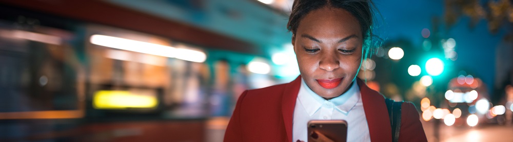 woman looking at mobile phone customer experience