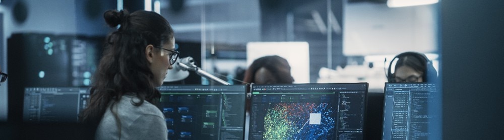 cyber security consultant looks at data on multiple screens cyber security consultant looks at data on multiple screens