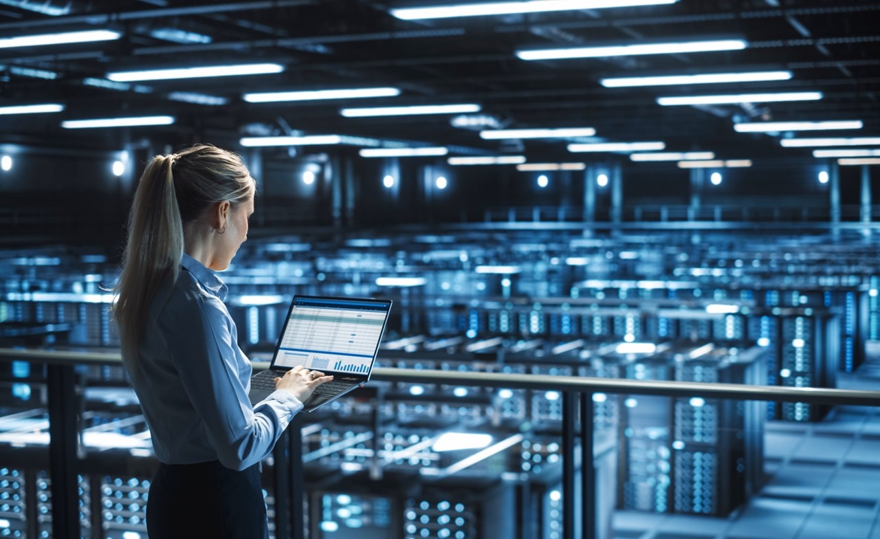 Data center IT specialist using a laptop computer
