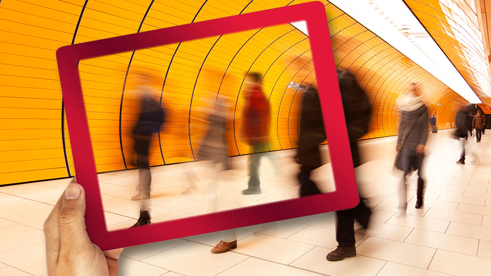 Abstract of digital transformation, and blurred people moving through a subway.