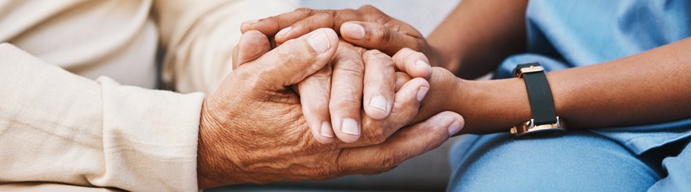 Doctor holding patient's hands