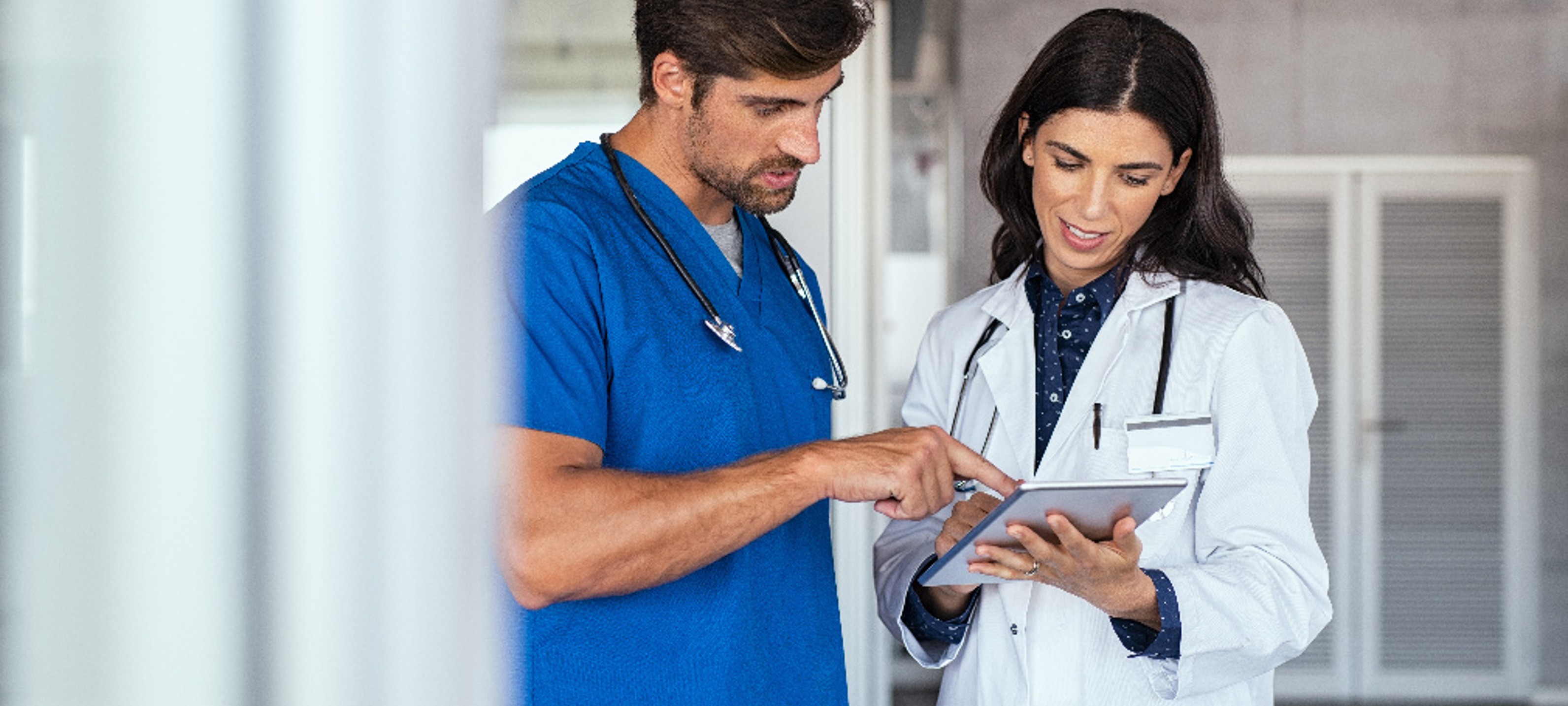 Doctors looking at a table Doctors looking at a table