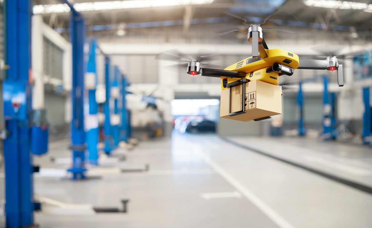 drone moving package on warehouse floor drone moving package on warehouse floor