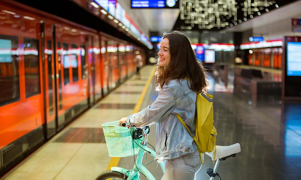 Young woman with a bike on a subway station in Helsinki