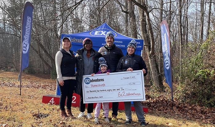Fundraising check CGI Partners presenting a fundraising check at race