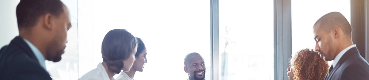 group-meeting-conference-room-618192948 Group meeting around a conference room table