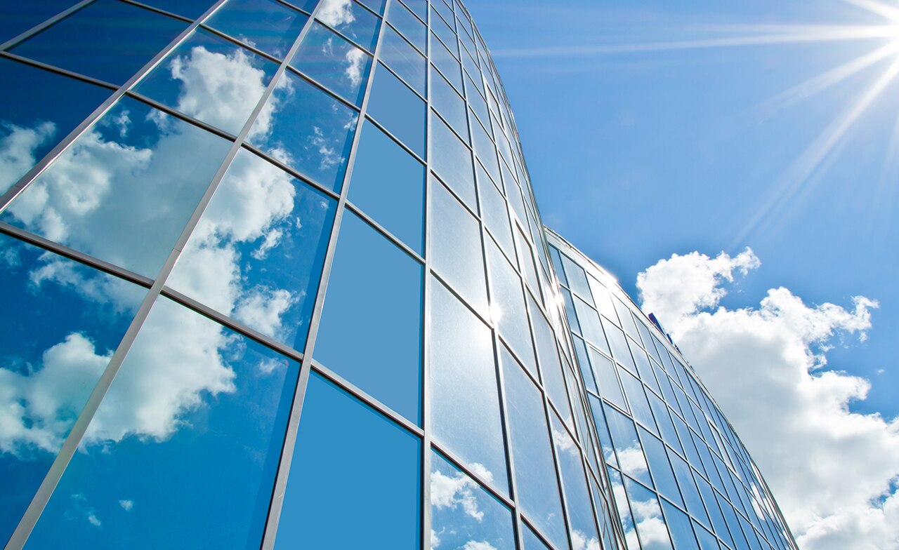 clouds reflected on building windows