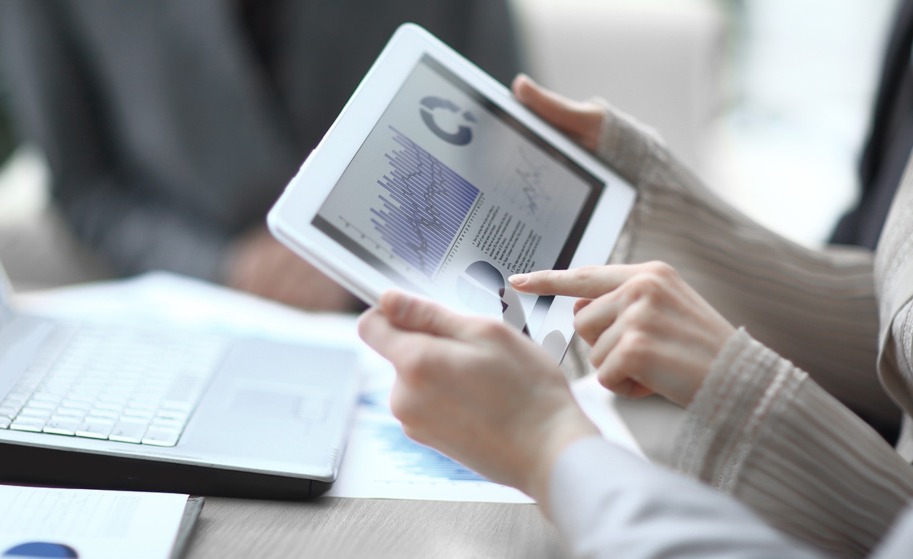 Trade professional checking analytics on a tab