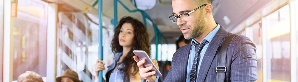 Passengers travelling on public transport with mobile app