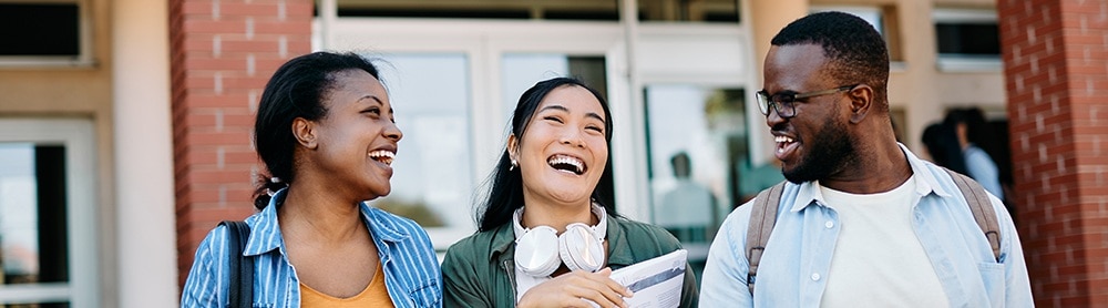 lebanon_delivery_center_body_image_2_mobile Three young adults laughing and talking while walking out of a building