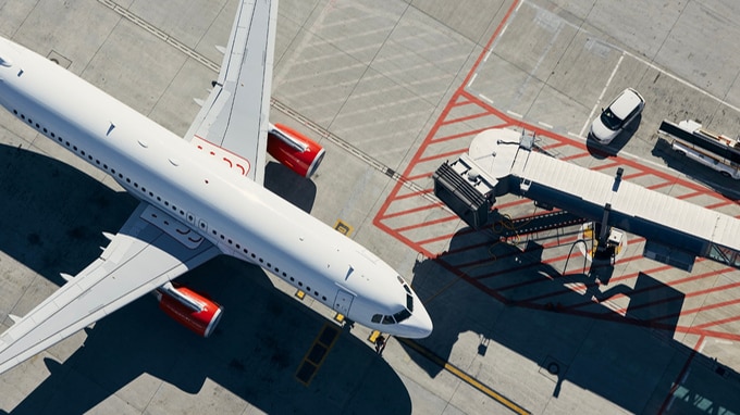 an arial view of an airplane at an airport gate