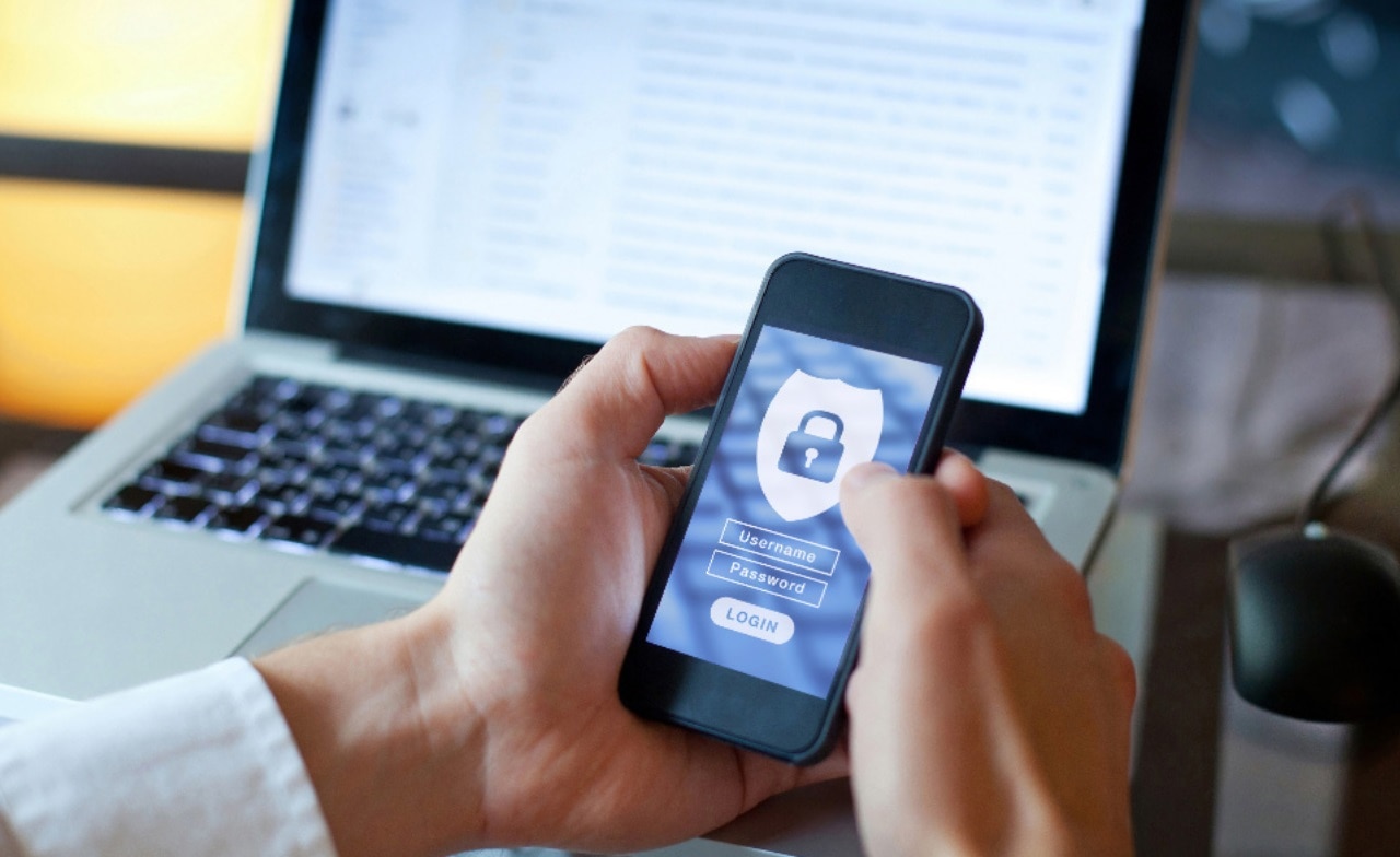 Man with security lock in mobile phone