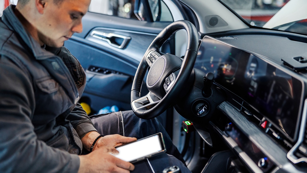 mechanic is using tablet for technical review