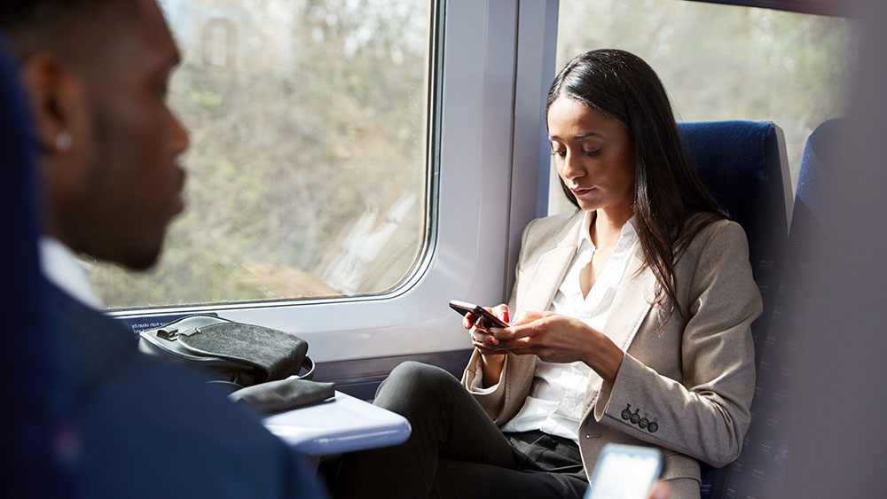 Woman looking at phone on train