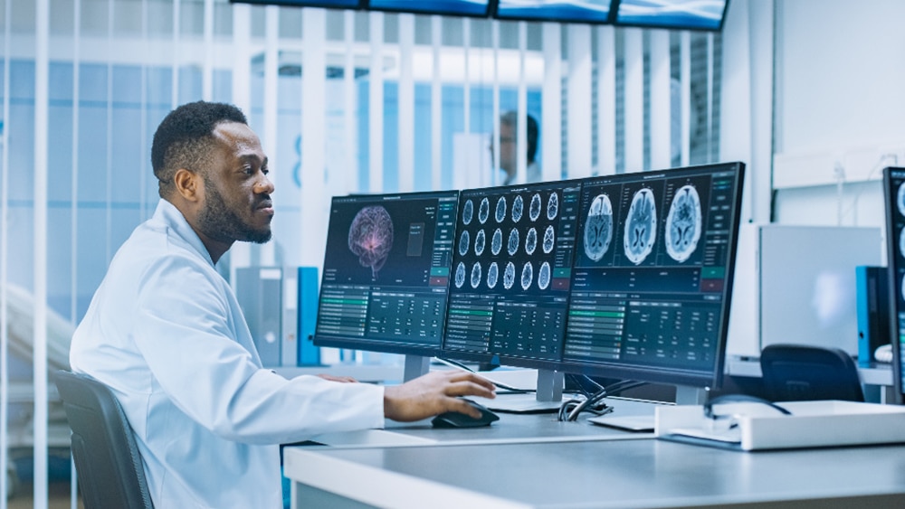 Clinician looking at brains scans on a computer