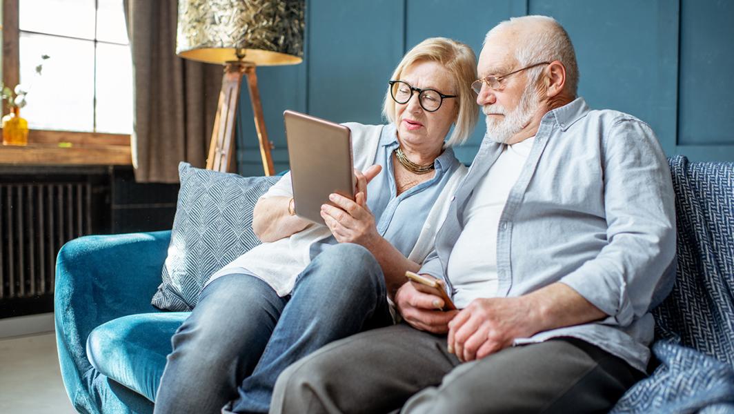 elderly couple accessing digital health applications from home
