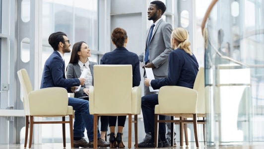 five consultants sat in discussion around a table