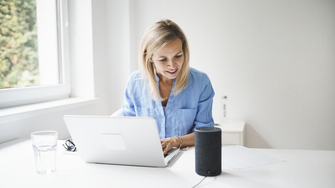  lady at laptop speaker to smart speaker 