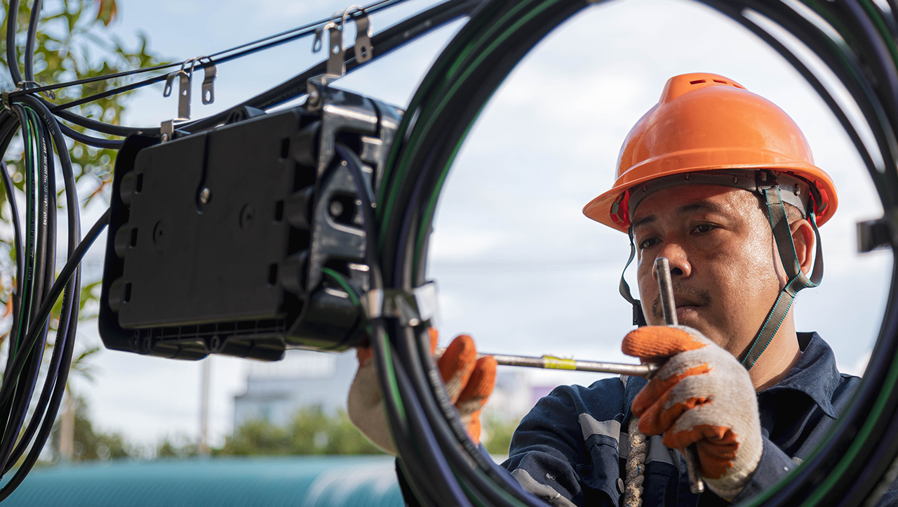 Technician working on fibre optic cable for maintenance