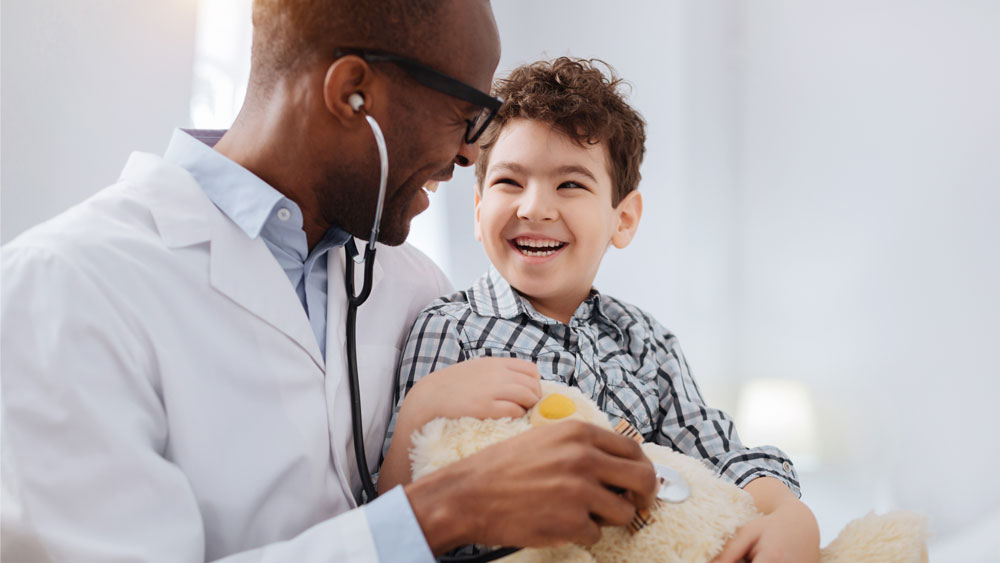 Doctor laughing with child