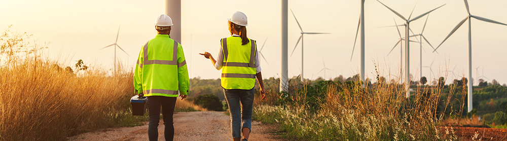 workers in high vis jackets at wind farm