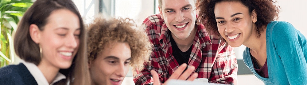smiling group of people reading document
