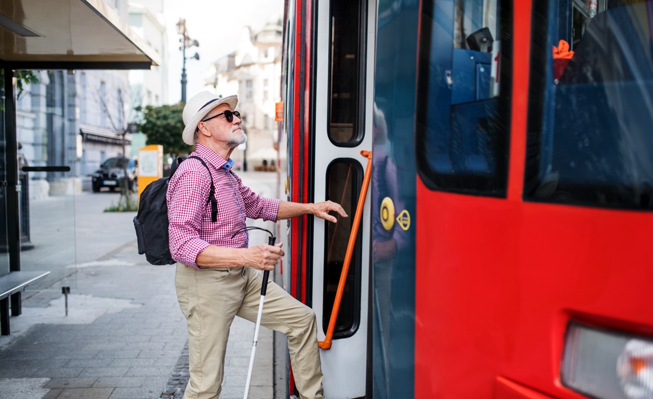 Old man stepping into bus